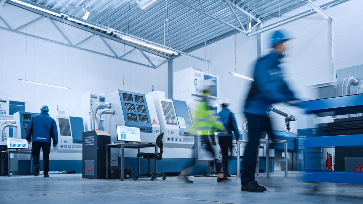 Blurred Motion Shot of a Team of Engineers, Professionals and Workers, Working on Assembly and Production Line, Optimizing CNC Machinery, Programming Machines.