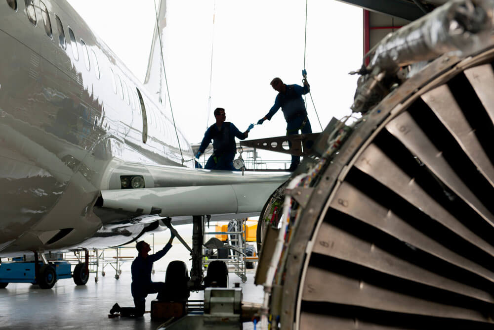 Engineers-assembling-the-wing-of-a-passenger-jet-at-a-hangar